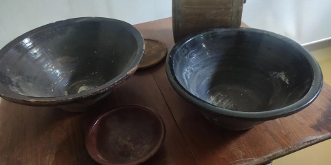 Dark brown clay pots sitting on a table
