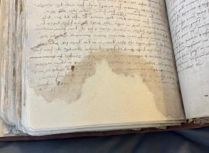 Open archival book with repaired pages.