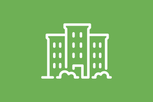 Icon in white of a building with bushes in front over a green background.