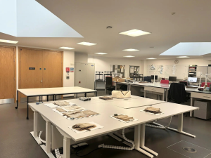 Photograph showing the PRONI conservation studio - On a large desk in the middle of the studio are several original records that are being conserved.