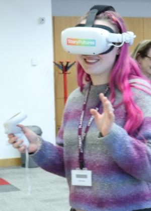 A girl with pink hair is wearing a VR headset with a controller in her hand