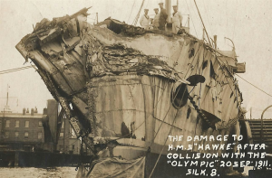 Black and white photograph showing the severely damaged bow of a ship. The handwritten text in white on the image reads "The damage to H.M.S Hawke after collision with the Olympic 20 Sep 1911. Silk 8."