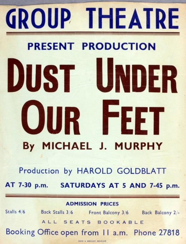 Photograph of an original poster for the play Dust Under Our Feet by Michael J Murphy. The title and author are written in maroon coloured writing while the rest of the poster is in royal blue.