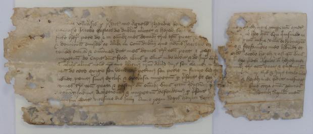 Small archival document with a rip down the middle and tearing around the edges.