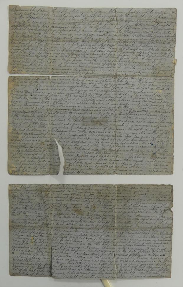 Archival document on blue paper with long text on the front. The page is ripped in half and has a tear on the bottom edge of the top half.